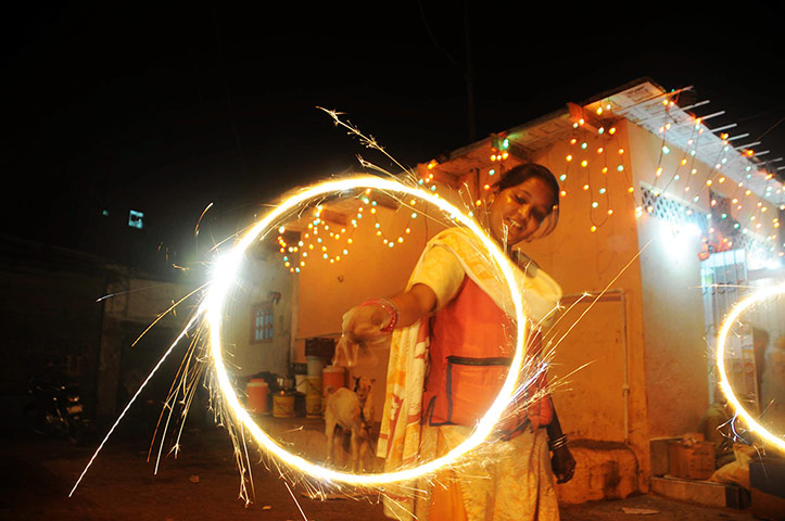 Diwali: A Hindu woman waves sparklers in Karachi, Pakistan