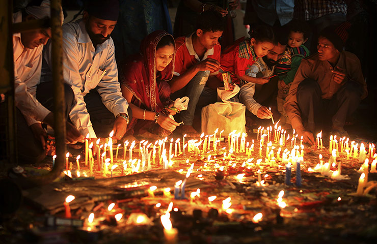 Diwali: Indians light candles during the festival of Diwali