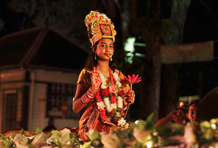 Diwali: A girl dressed as Lakshmi, the Hindu goddess of wealth, leads a procession