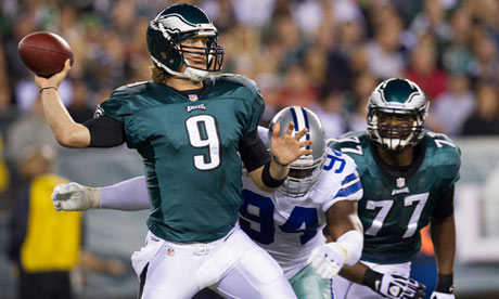 Philadelphia Eagles quarterback Nick Foles looks to throw as Dallas's DeMarcus Ware closes in