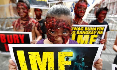  Filipino protesters dressed up as zombies hold their placards in a rally during the visit of International Monetary Fund (IMF) Managing Director Christine Lagarde 