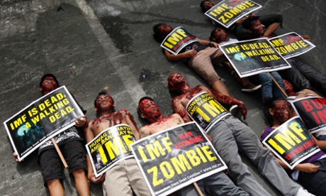 Filipino protesters dressed up as zombies lay on the ground in a rally during the visit of International Monetary Fund (IMF) Managing Director Christine Lagarde near the Malacanang presidential palace in Manila, Philippines, 16 November 2012. 