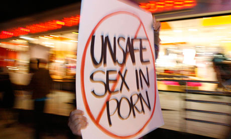 An activist holds a sign during a rally in support of Measure B