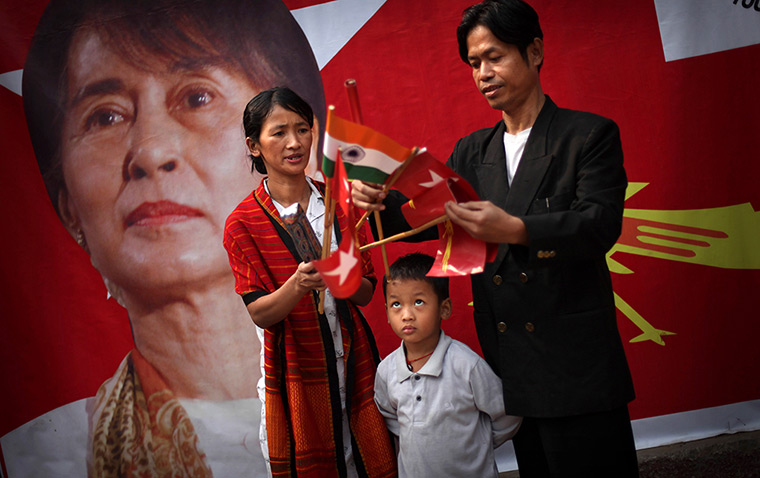 24 hours in pictures: A refugee couple with Indian and Burma flags with Aung San Suu Kyi poster