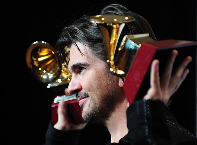 24 hours in pictures: Juanes poses with his trophies during the 13th Annual Latin Grammy show