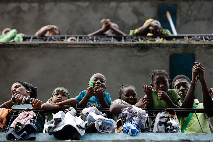 24 hours in pictures: Residents of the Kissy neighborhood stand on their balconies