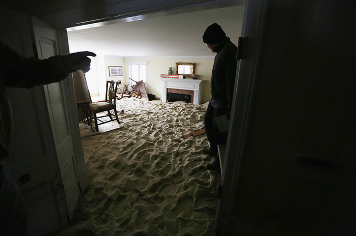 24 hours in pictures: Living room filled with sand washed in two weeks after Superstorm Sandy