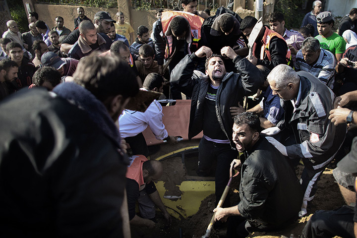 24 hours in pictures: A Palestinian man calls for help to save a man trapped under his car