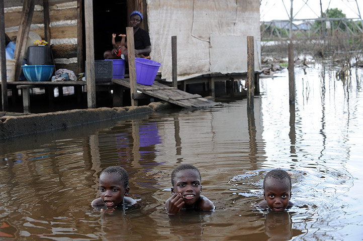 24 hours: Children swim in front of a flooded house in the town of Yenagoa