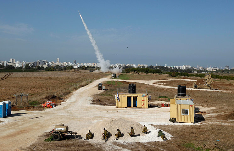 Gaza: Israeli soldiers watch as an Iron Dome launcher fires an interceptor rocket