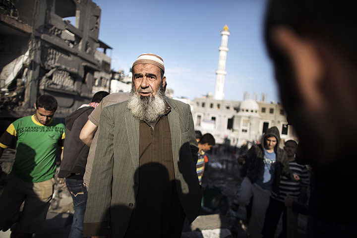 Gaza: A Palestinian man inspects damaged buildings following air strikes