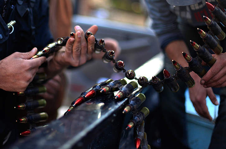 24 hours in pictures: Syrian fighters check their ammunition