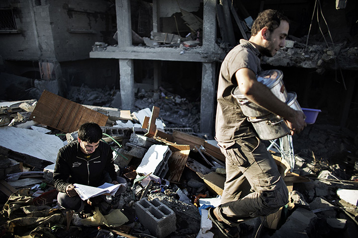 24 hours in pictures: Palestinians try to salvage items from their damaged house