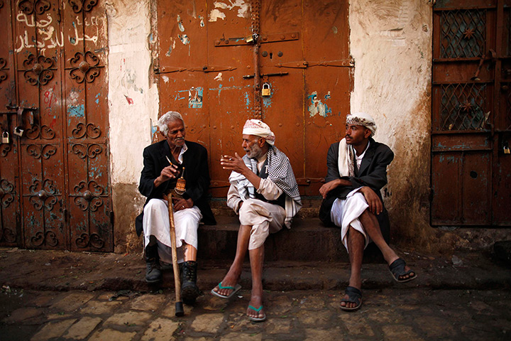 24 hours in pictures: People chat as they sit at a marketplace