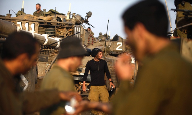 Israeli soldiers wake after sleeping in a deployment area on 19 November 2012 on Israel's border with the Gaza Strip. Photograph: Lior Mizrahi/Getty Images