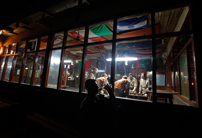 24 hours: Kabul, Afghanistan: A French soldier drinks at a French base