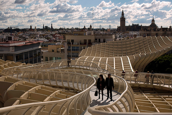 24 hours: Seville, Spain: A couple walk along a path on the Metropol Parasol