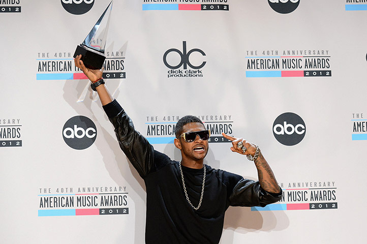 American Music Awards: Usher poses with his award at the American Music Awards