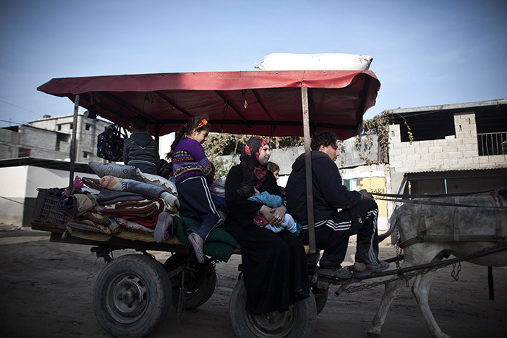 Gaza conflict: A Palestinian family fleeing airstrikes move to a safer area of Gaza City 