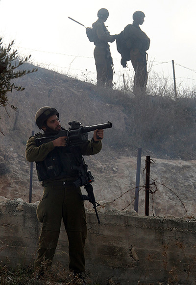 Gaza conflict: Israeli soldiers take position during clashes with Palestinians