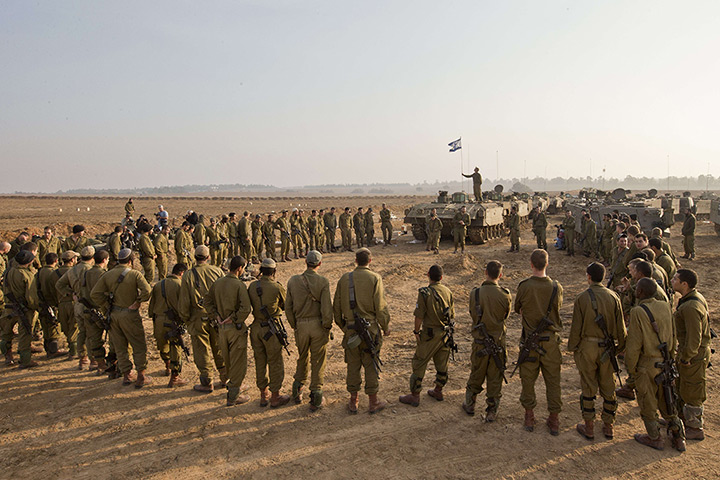 Gaza conflict: An Israeli tank squadron attend a morning briefing at the border with Gaza