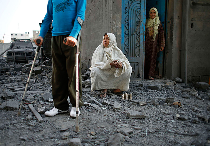 Gaza conflict: Locals look at  destruction after an Israeli air strike on nearby houses