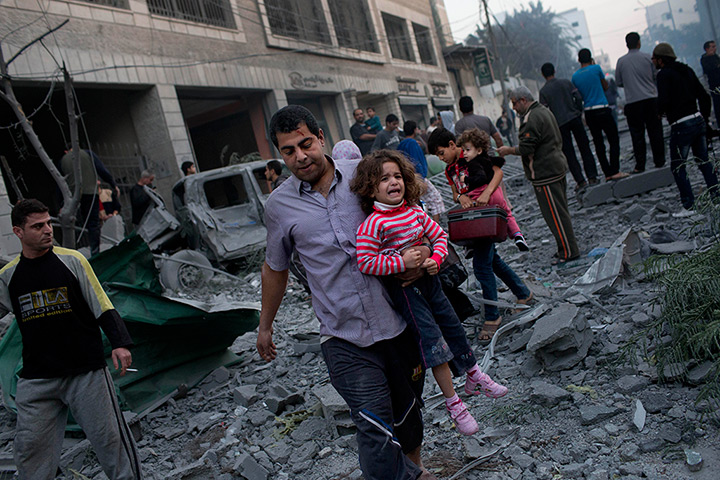 Gaza conflict: Palestinians flee their homes after an Israeli strike  in Gaza City, Monday