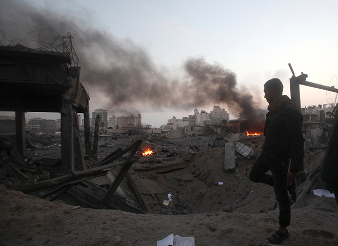 Gaza conflict: A man walks past the remains of a Hamas building n Gaza City 