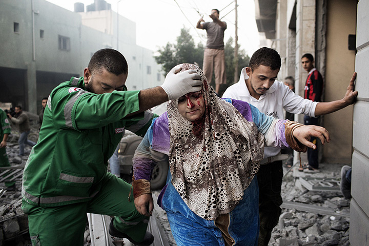 Gaza conflict: A woman is evacuated by a paramedic
