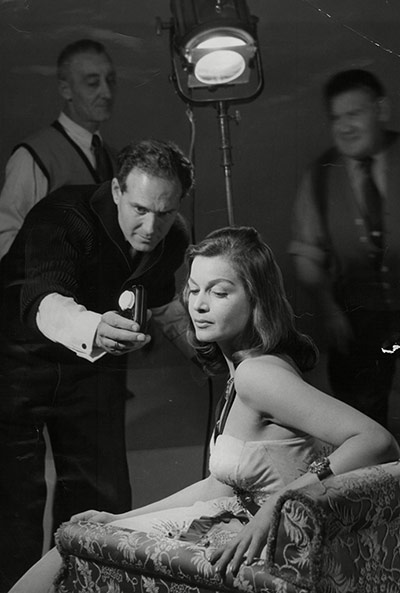 Cornel Lucas: Cornel Lucas takes a light reading for Eva Bartok's portrait