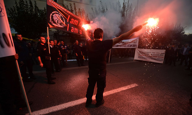 A port police officer lights flares duri