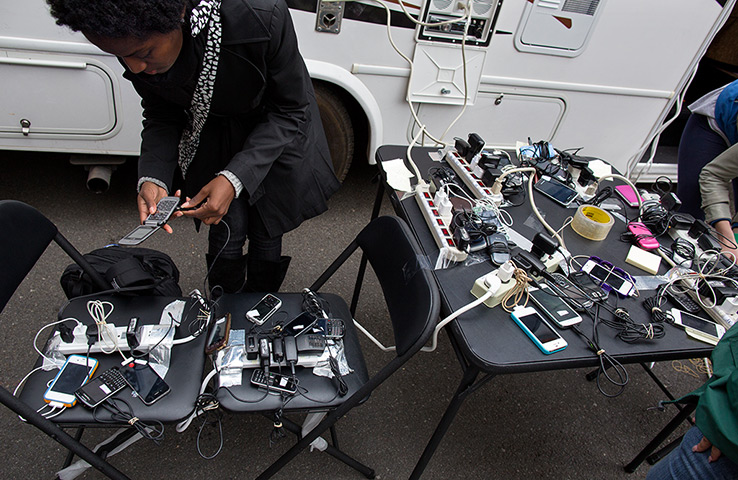 Superstorm sandy supplies: Tunisia Wragg checks a cell phone at a charging station in the Chinatown