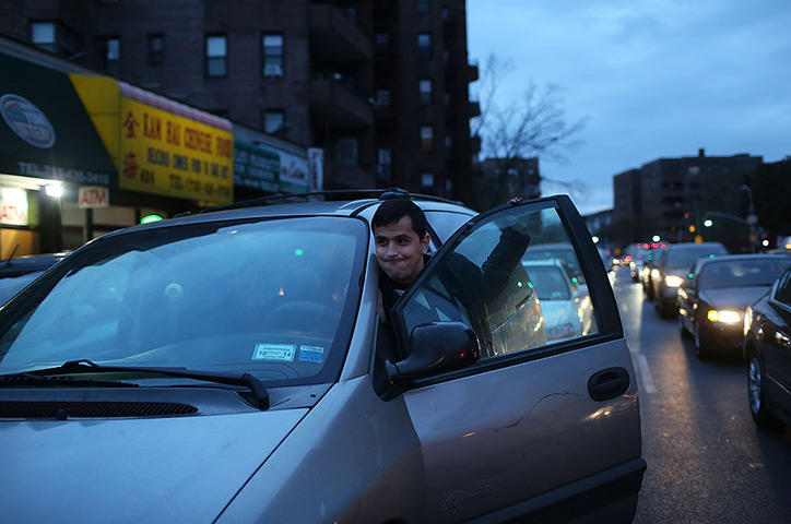 Superstorm sandy supplies: Jahongir Ibadov pushes his car in a long line at a filling station