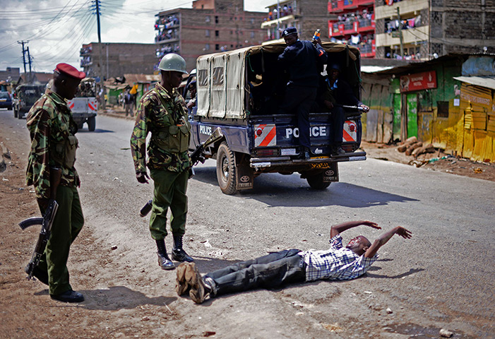 24 hours: Nairobi, Kenya: Kenyan police officers detain a man