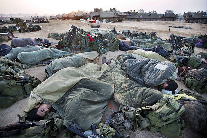 Israel Gaza : Israeli soldiers sleep near armoured personnel carriers