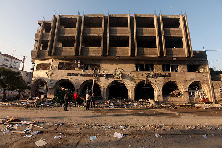 Israel Gaza : Palestinians inspect the damage after a strike on the bank in Gaza City