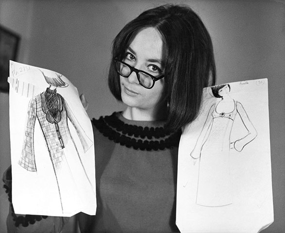 Caroline Charles : Caroline Charles holding design sketches, 1964