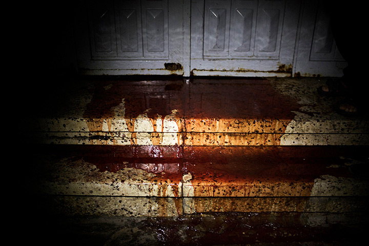 gaza conflict : Blood leaks from under the door of the al-Shifa hospital morgue in Gaza