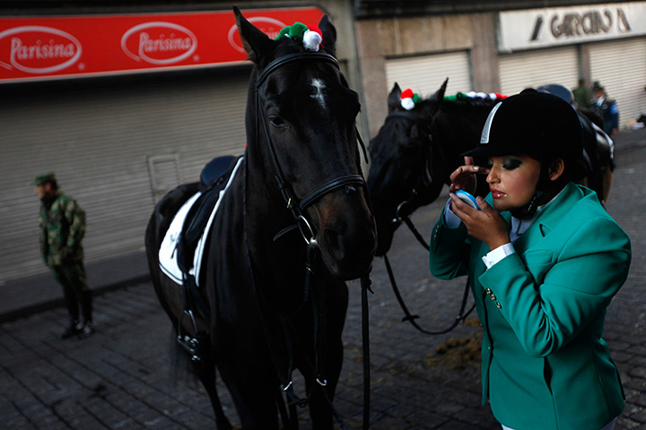 24 hours: Mexico City, Mexico: A soldier from the mounted cavalry unit puts on makeup
