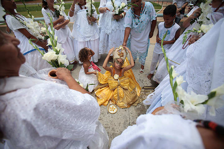24 hours: Brasilia, Brazil: A girl dressed in ceremonial Oxun clothing