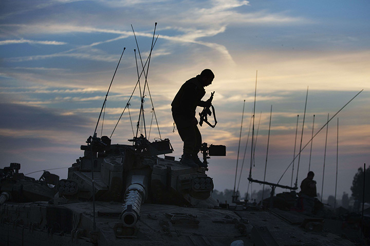 24 hours: Israel-Gaza Strip border: Israeli soldiers stand on vehicles stationed