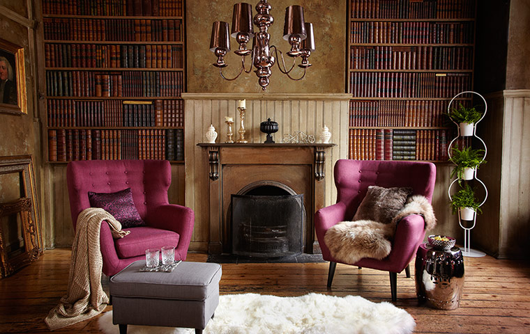 Homes: Luxe: Image of living room with old fashioned bookshelves and armchairs