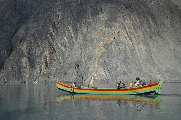 Your Pictures: Colour: A boat on a lake in Pakistan sets off the colour of the rock