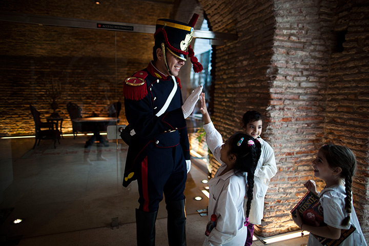 24 hours: Buenos Aires, Argentina: Children high five a man dressed as a soldier