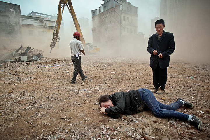 China demolition: A woman who tried to protect her house being demolished cries 