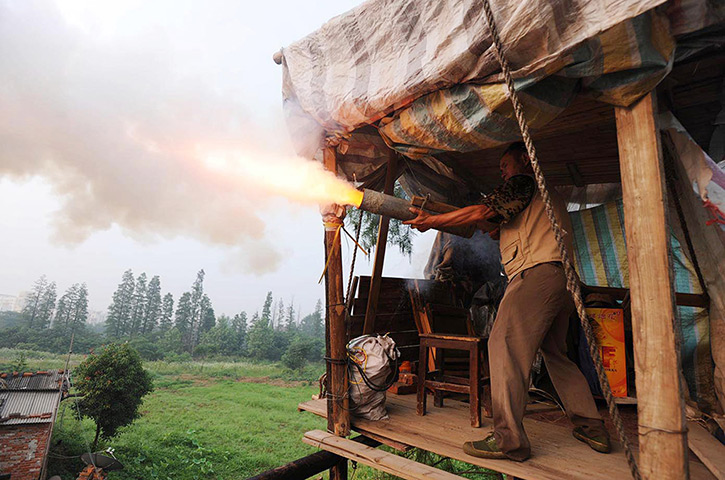 China demolition: Chinese farmer Yang Youde fires his homemade cannon