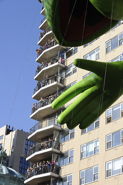 Thanksgiving: People fill balconies as the Kermit The Frog balloon passes by
