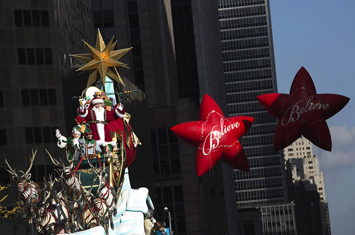Thanksgiving: A man portraying Santa Claus waves to the crowd 