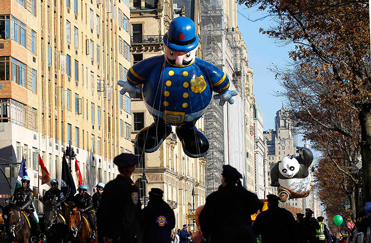 Thanksgiving: The Harold the Policeman balloon floats down Central Park West 