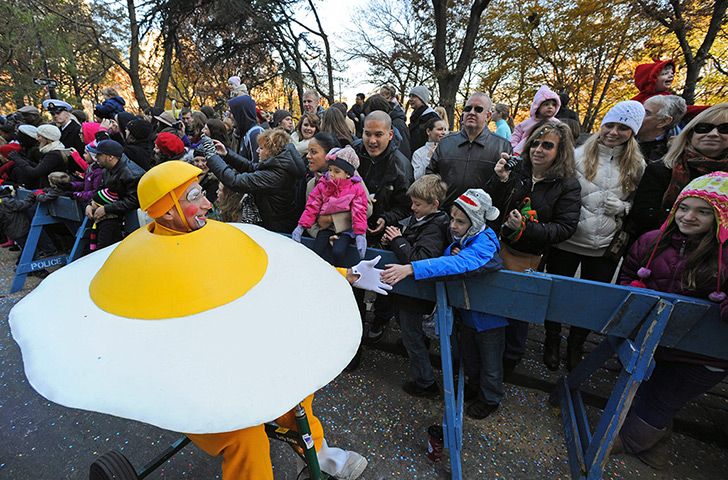 Thanksgiving: A performer dressed as an egg greets children 